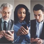Diverse group of businesspeople reading text messages on cellphones